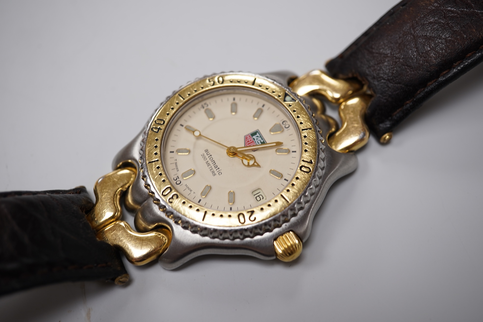 A gentleman's recent stainless steel and gold plated Tag Heuer automatic wrist watch, on an associated leather strap, case diameter 38mm, with Tag box and 2023 service guarantee card.